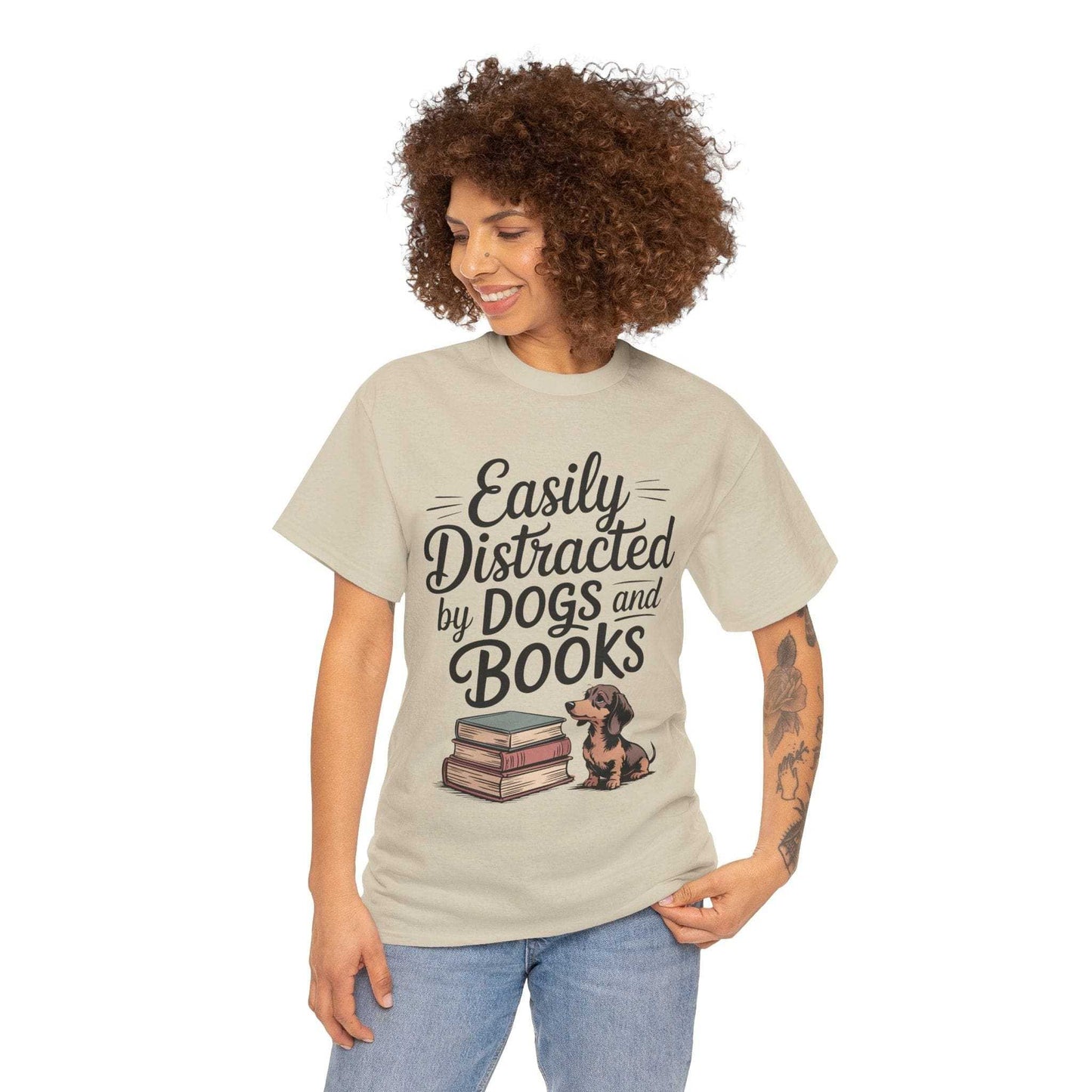 Woman wearing a beige t-shirt with 'Easily Distracted by Dogs and Books' text and graphic.