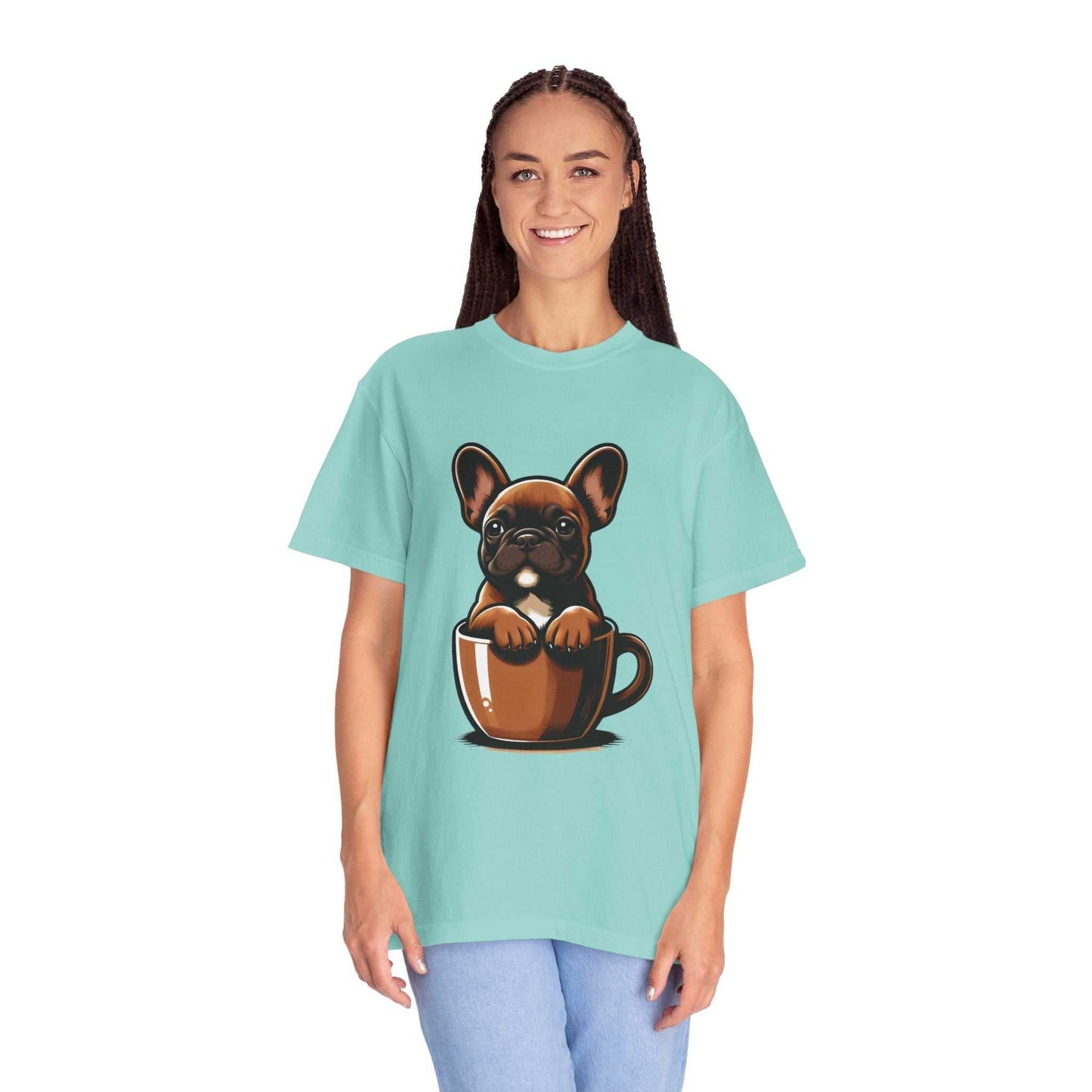 Person wearing a light blue t-shirt with a graphic of a dog in a coffee cup on a white background