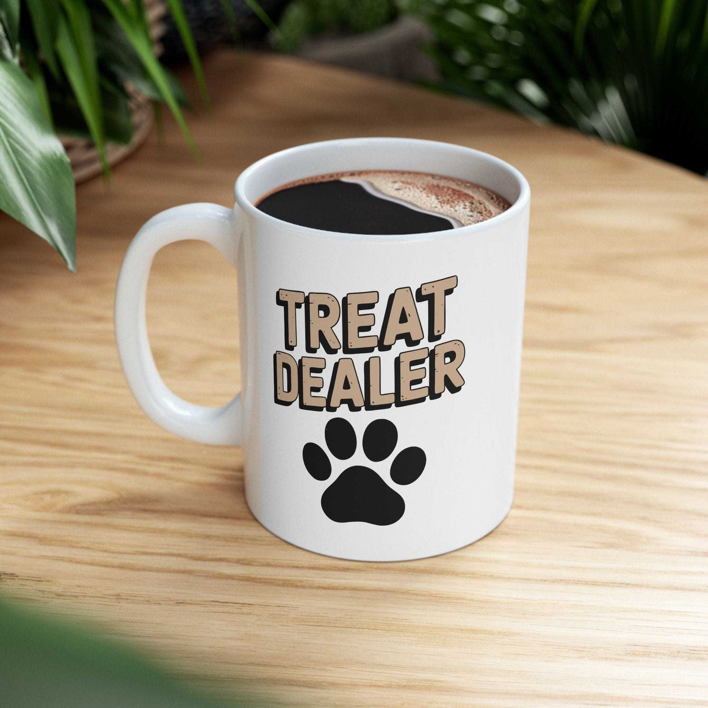 White mug with 'Treat Dealer' text and paw print on a wooden surface
