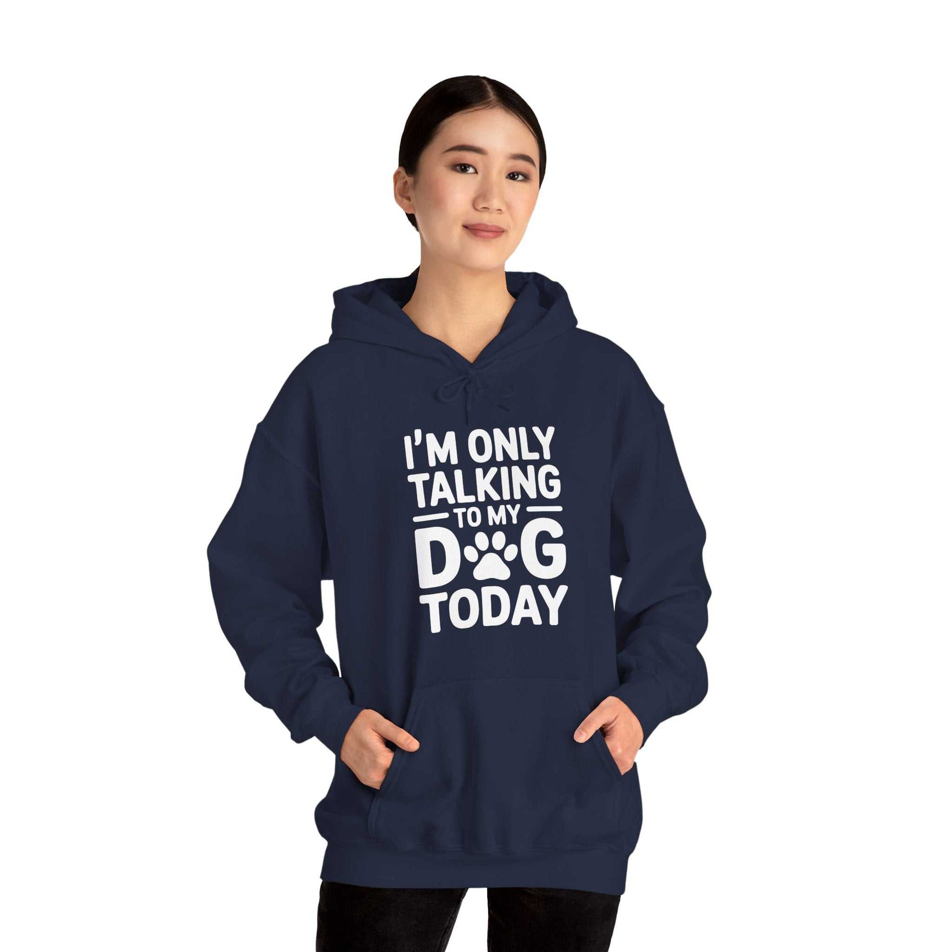 Person wearing a navy hoodie with 'I'm only talking to my dog today' text on a white background