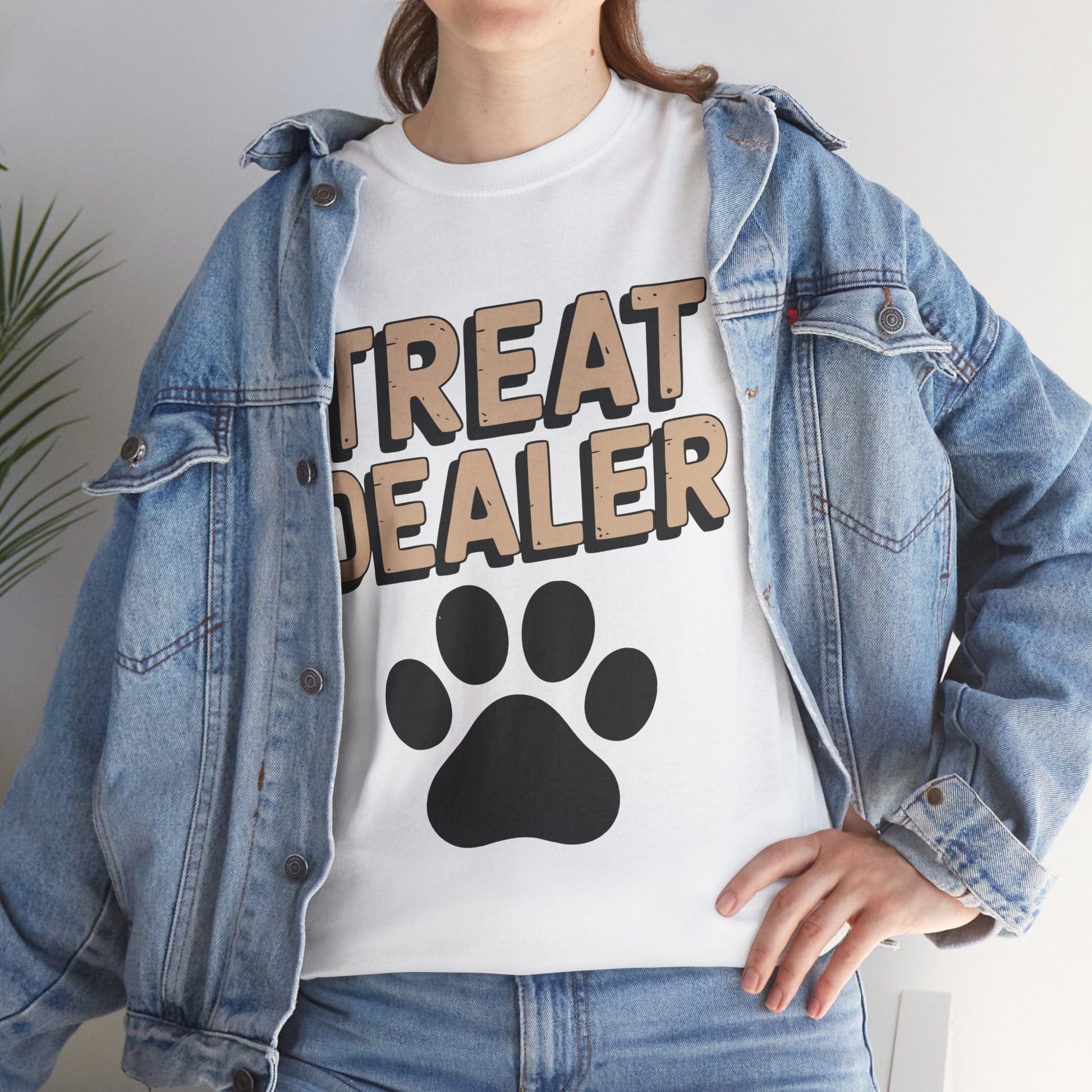 Person wearing a white t-shirt with 'TREAT DEALER' and a paw print design, paired with a denim jacket.