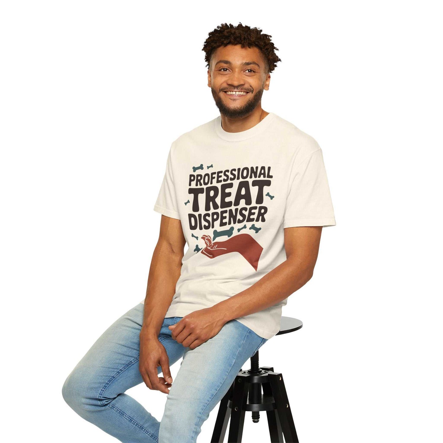 Man sitting on a stool wearing a white t-shirt with text and graphics.