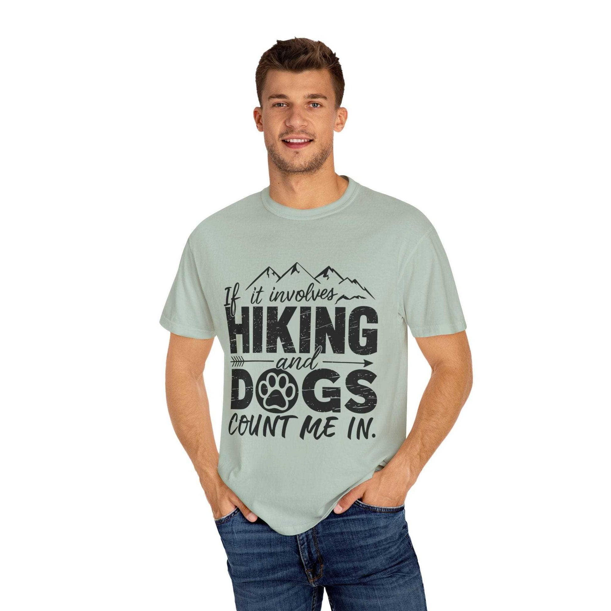 Man wearing a light green t-shirt with text 'If it involves hiking and dogs, count me in.' on a white background