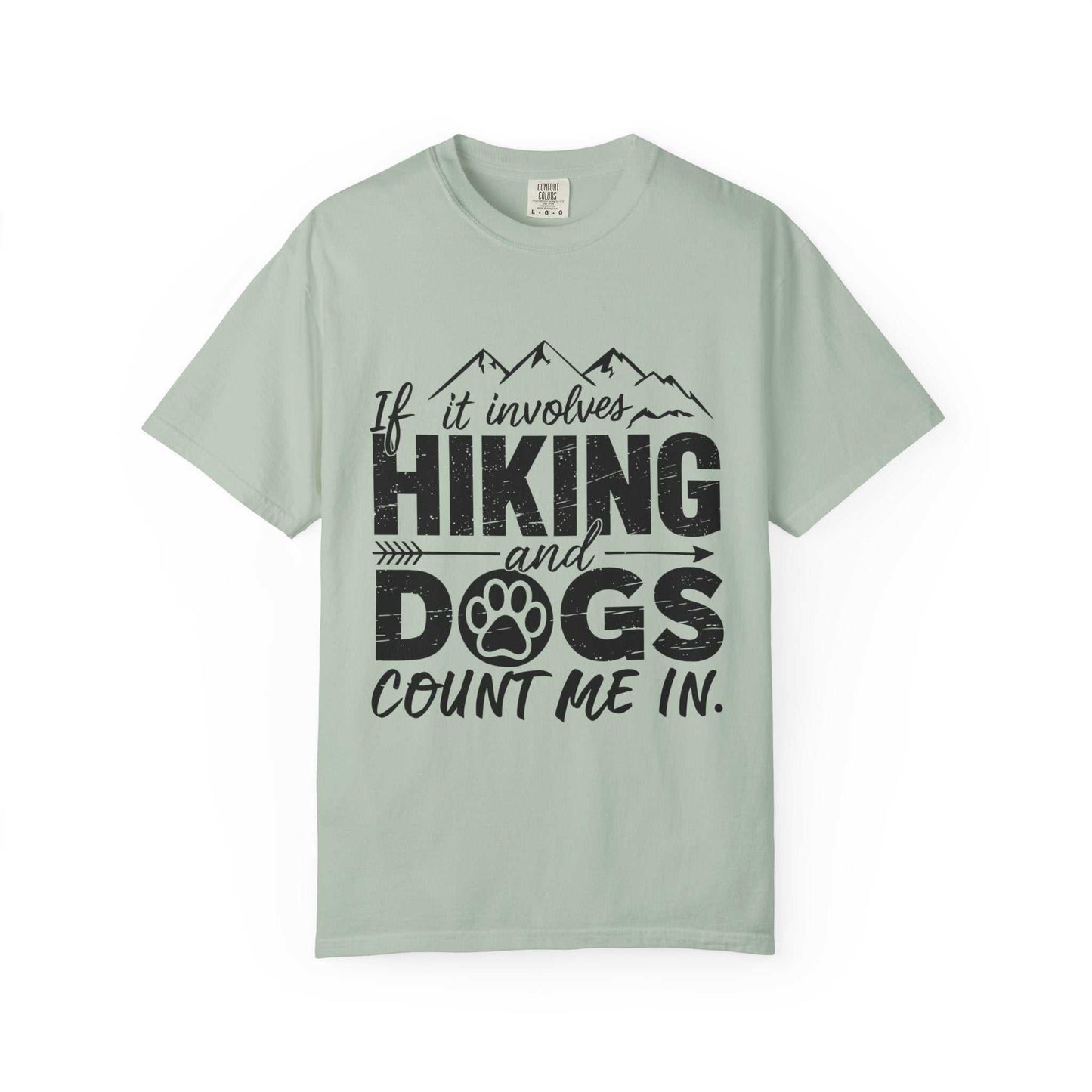 Light green t-shirt with black text 'If it involves hiking and dogs count me in.' on a white background