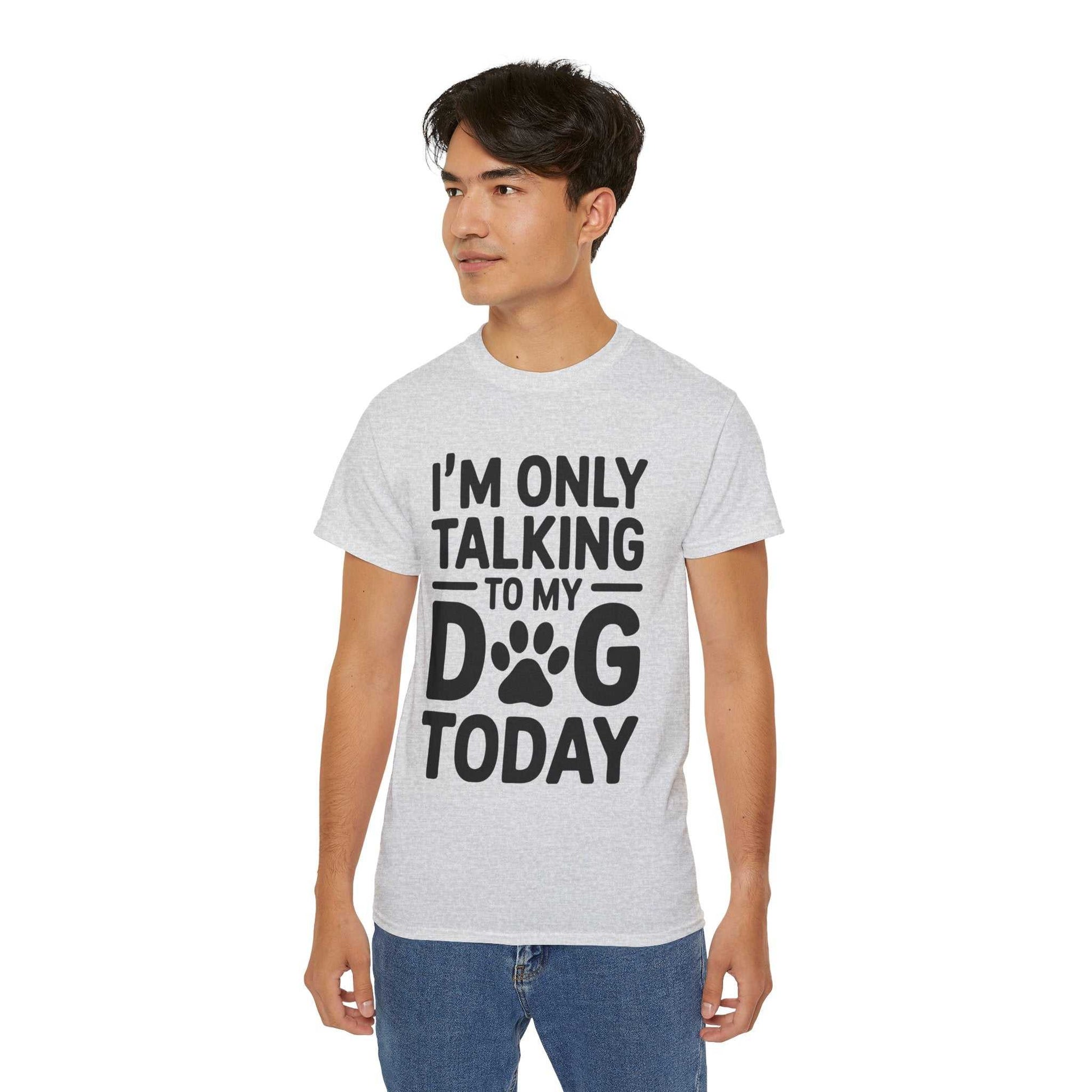 Person wearing a gray t-shirt with text 'I'm only talking to my dog today' on a white background