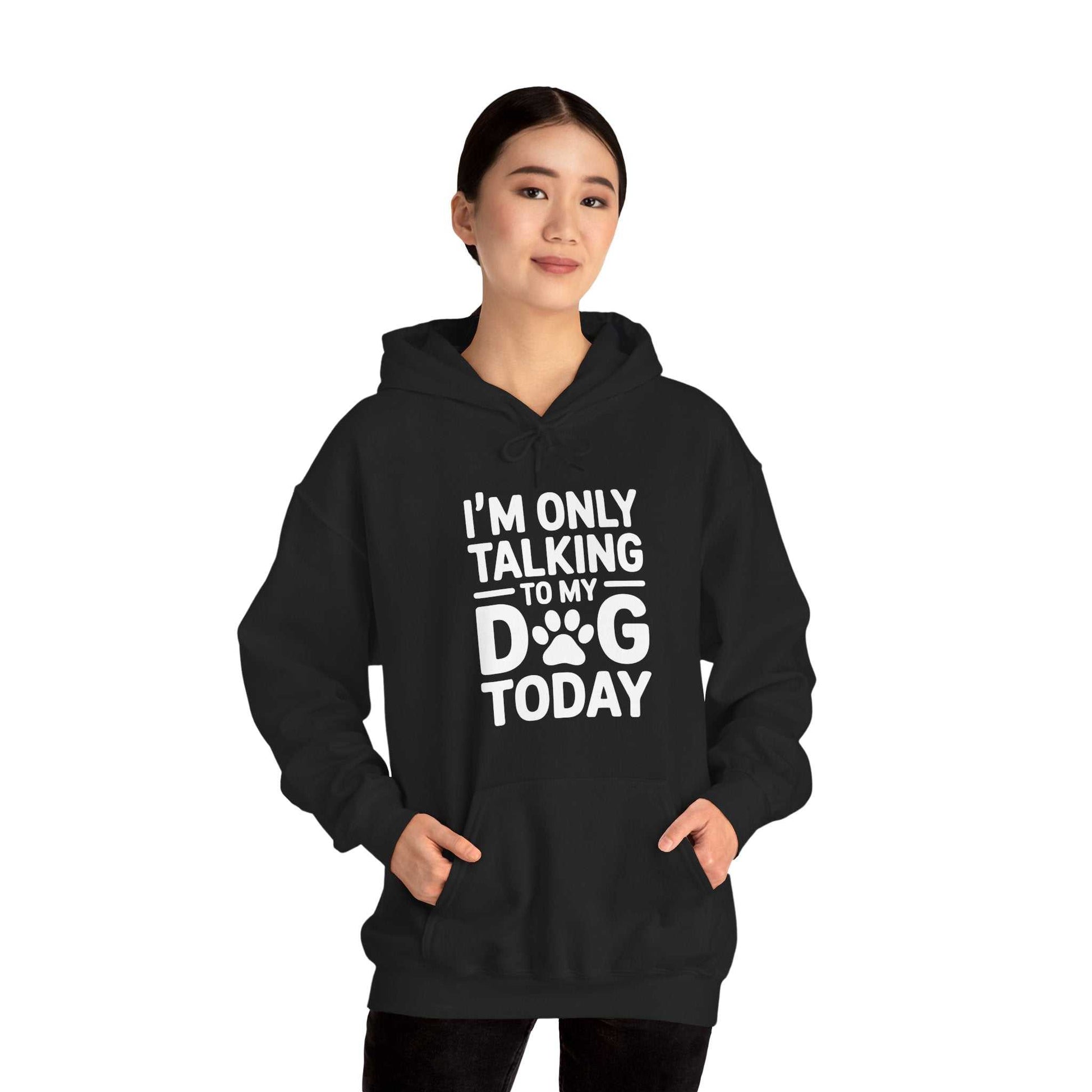 Person wearing a black hoodie with 'I'm only talking to my dog today' text on a white background