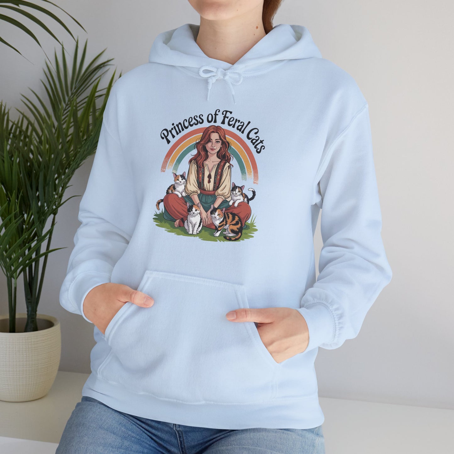 Light blue hoodie with 'Princess of Feral Cats' design featuring a woman and cats, worn by a person.