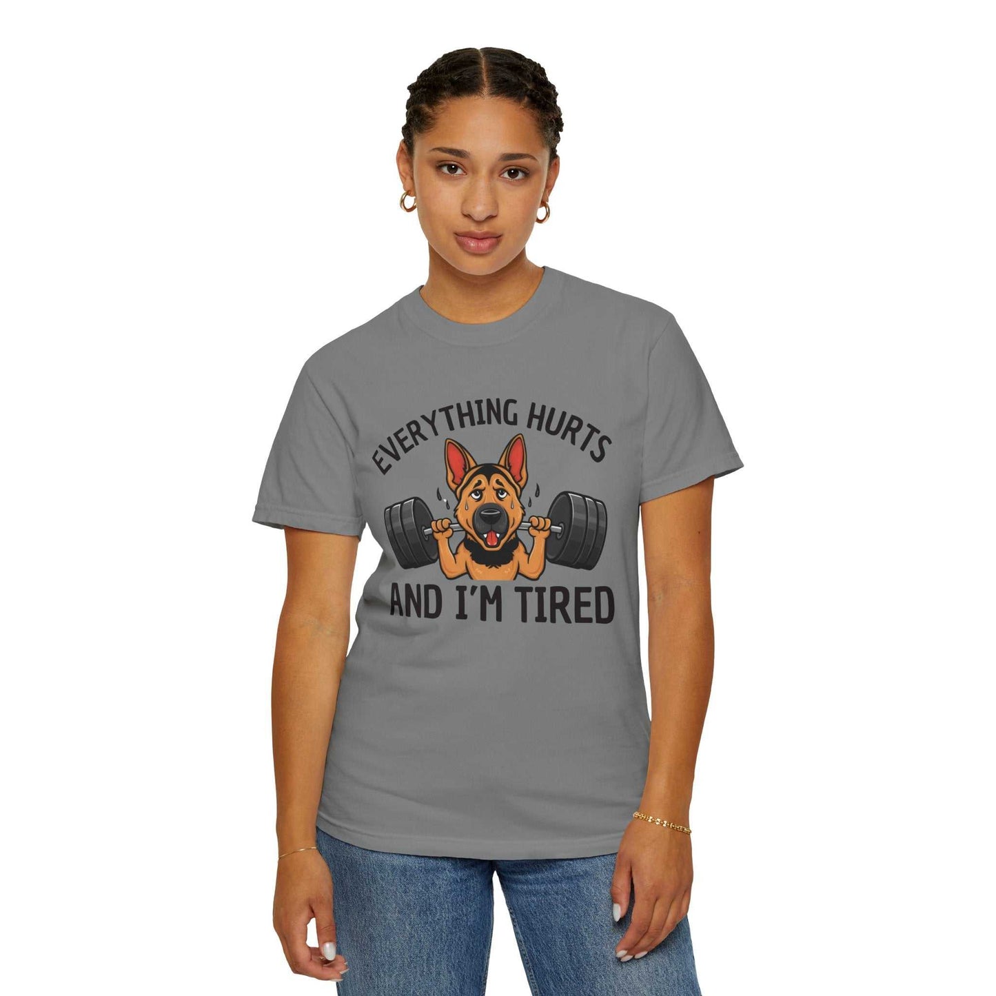 Person wearing a gray t-shirt with a dog lifting weights graphic and text.