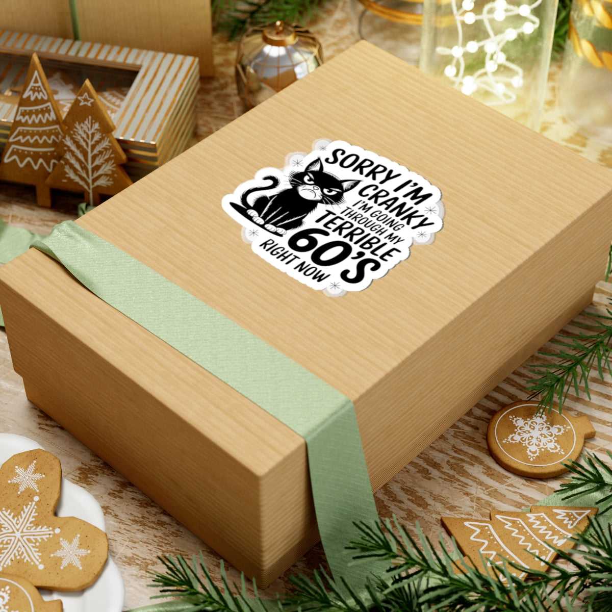 Wooden gift box with a humorous sticker on a festive background with cookies and greenery.
