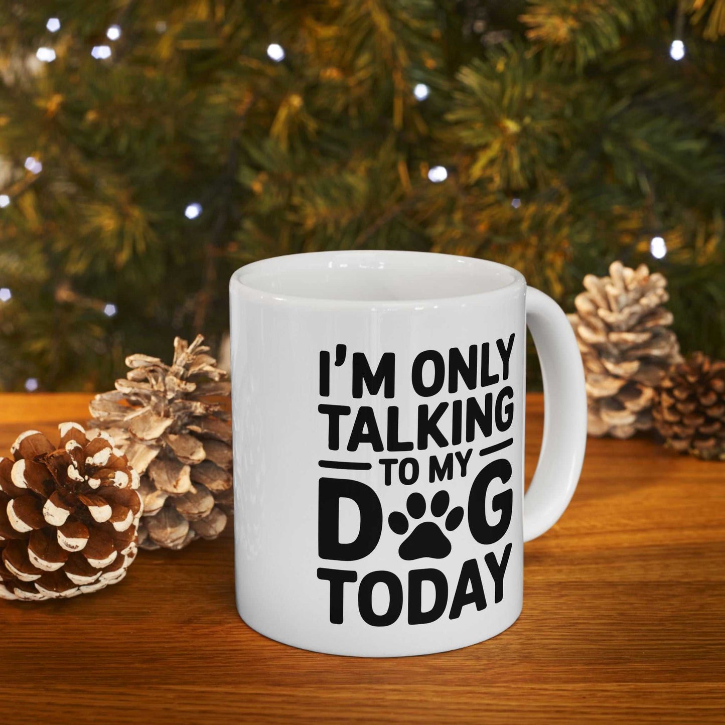 White mug with 'I'm only talking to my dog today' text in front of a Christmas tree.