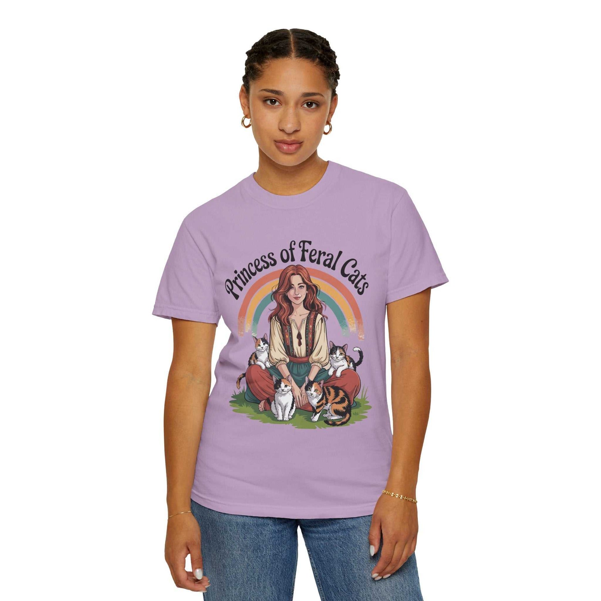 Person wearing a purple t-shirt with a graphic design of a woman and cats, with the text 'Princess of Feral Cats'.