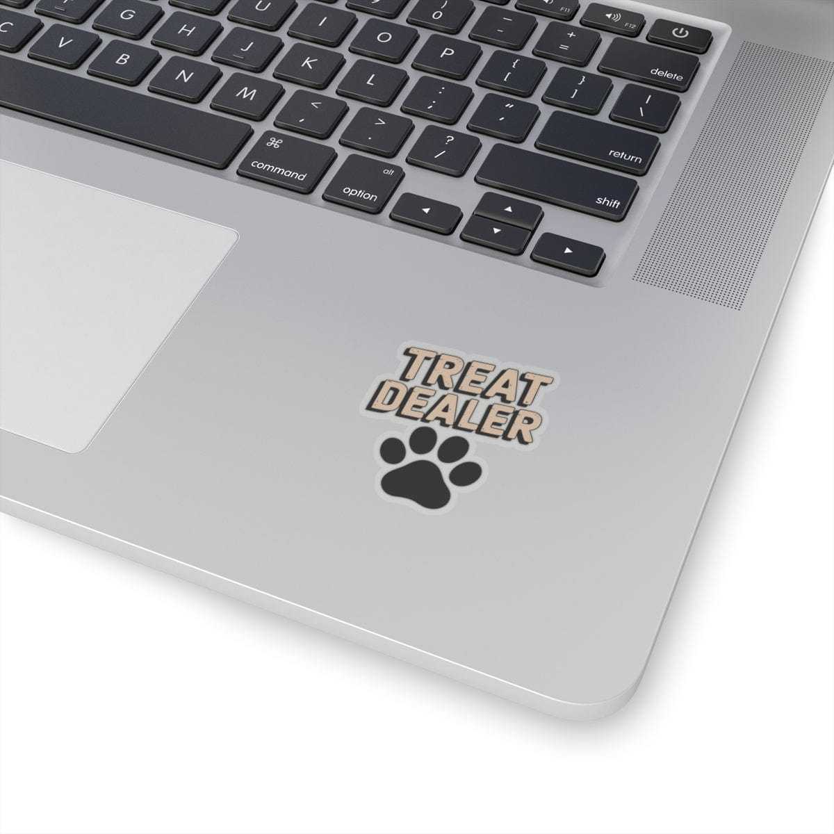 Laptop with 'Treat Dealer' and paw print sticker on the palm rest area