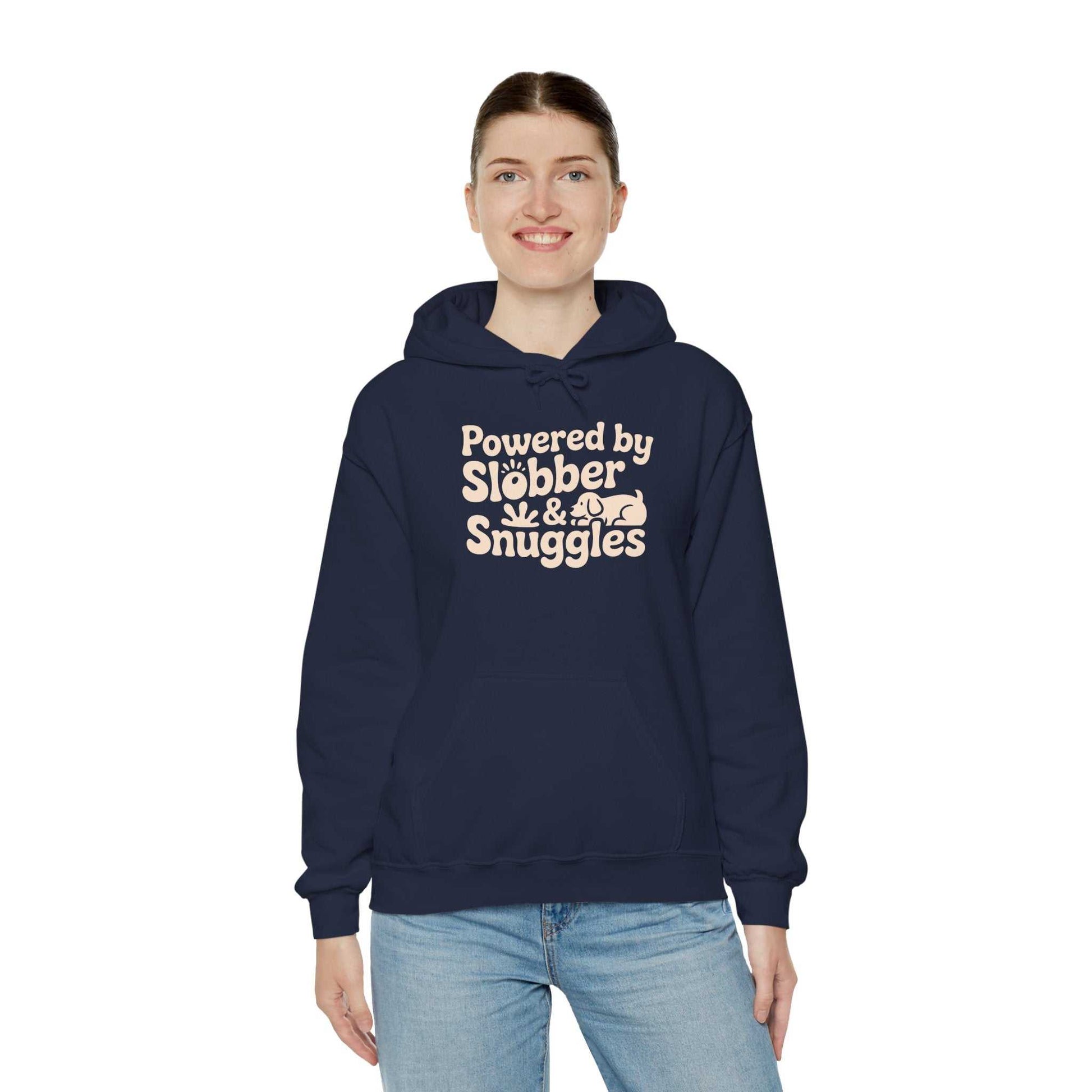 Person wearing a navy hoodie with 'Powered by Slebber & Snuggles' text on a white background