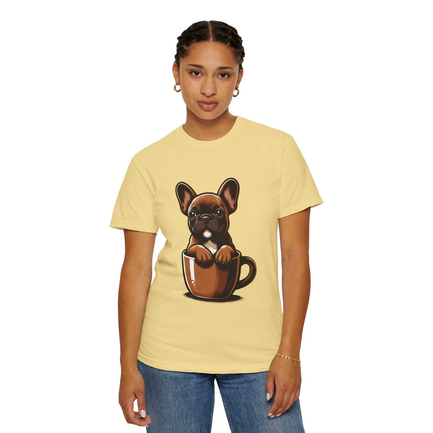 Person wearing a yellow t-shirt with a graphic of a dog in a coffee cup on a white background