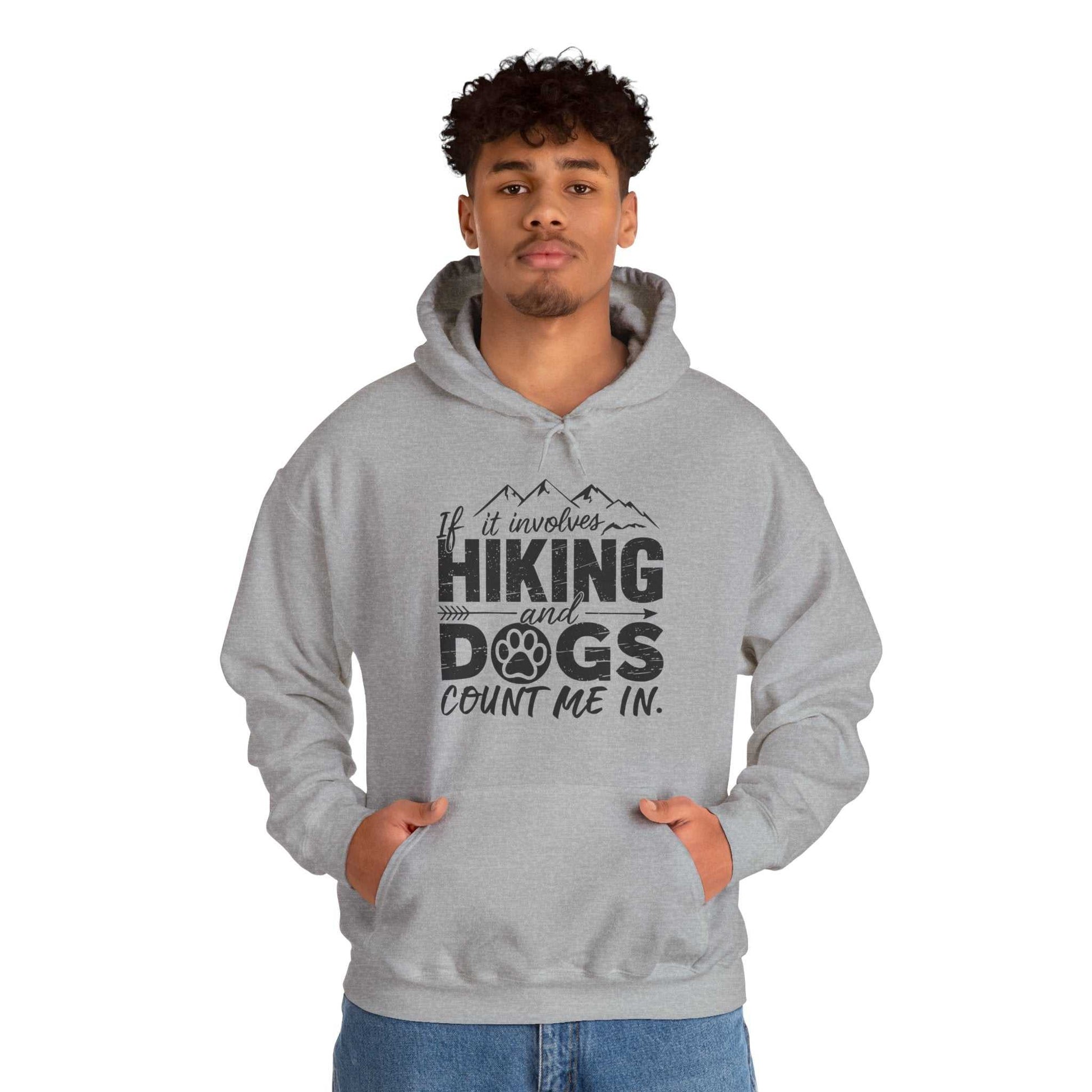 Person wearing a gray hoodie with text 'If it involves hiking and dogs, count me in' on a white background