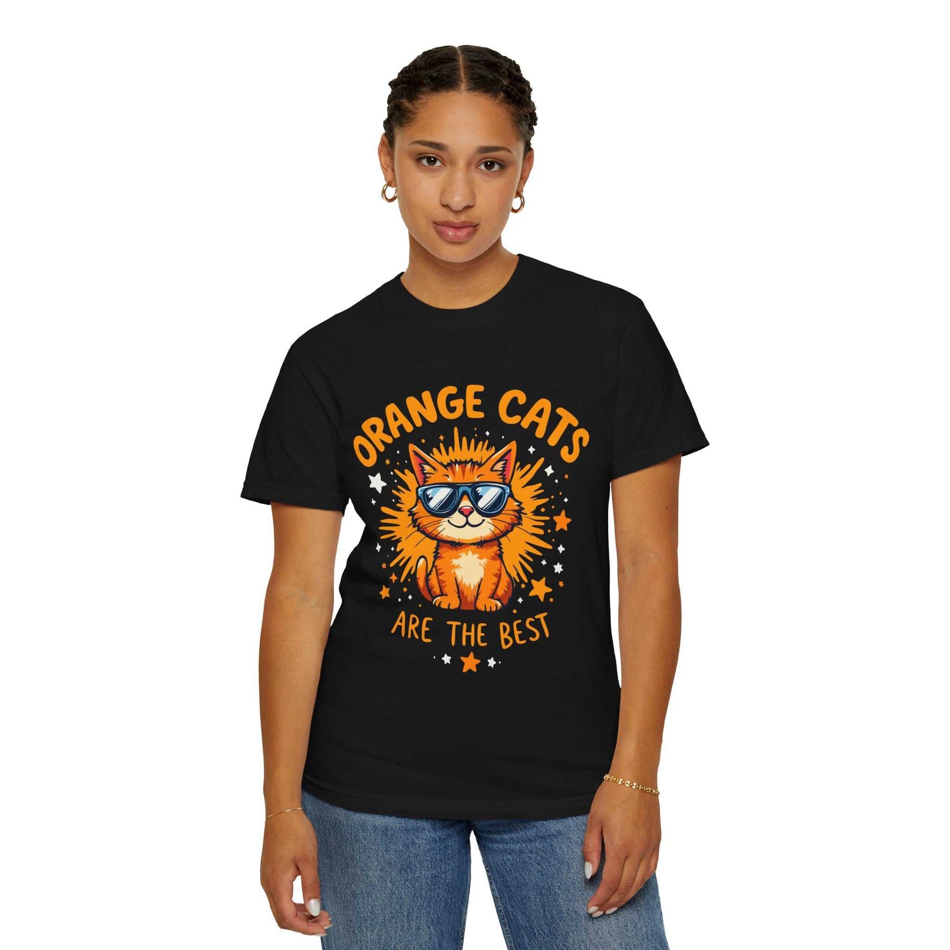 Person wearing a black t-shirt with an orange cat graphic and text on a white background