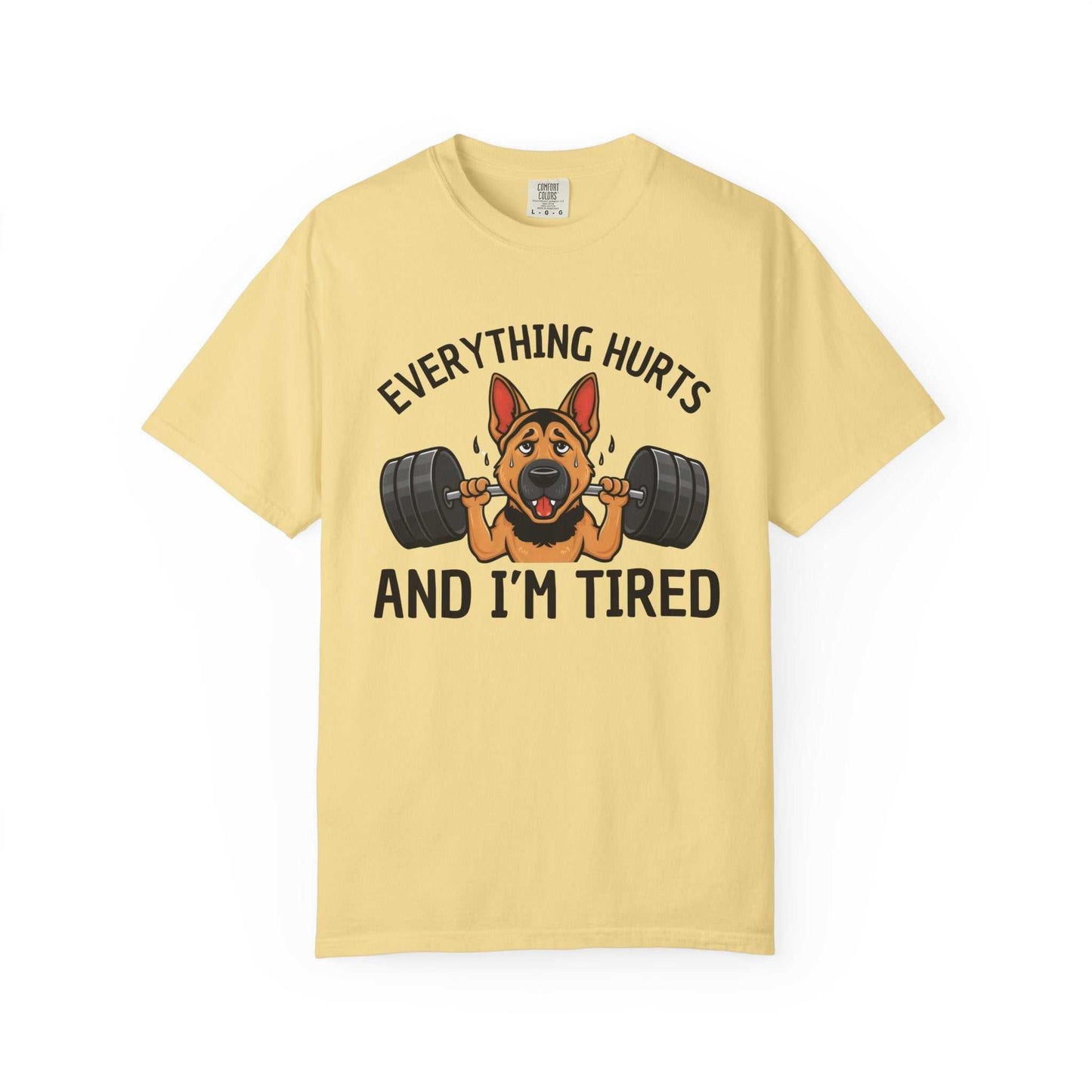 Yellow t-shirt with a graphic of a dog lifting weights and text 'Everything hurts and I'm tired' on a white background.