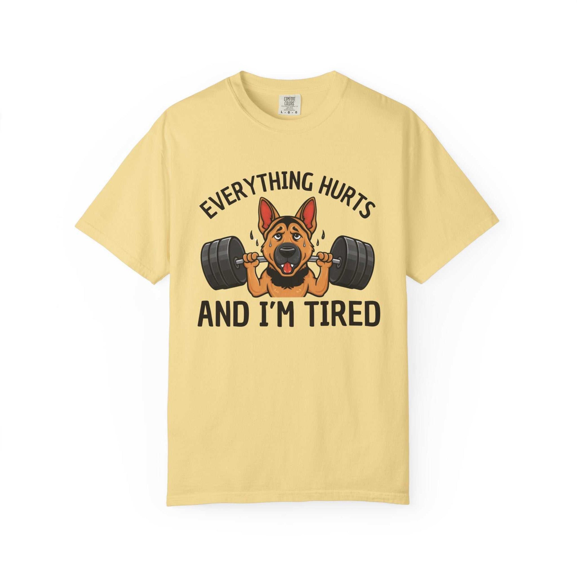 Yellow t-shirt with a graphic of a dog lifting weights and text 'Everything hurts and I'm tired' on a white background.