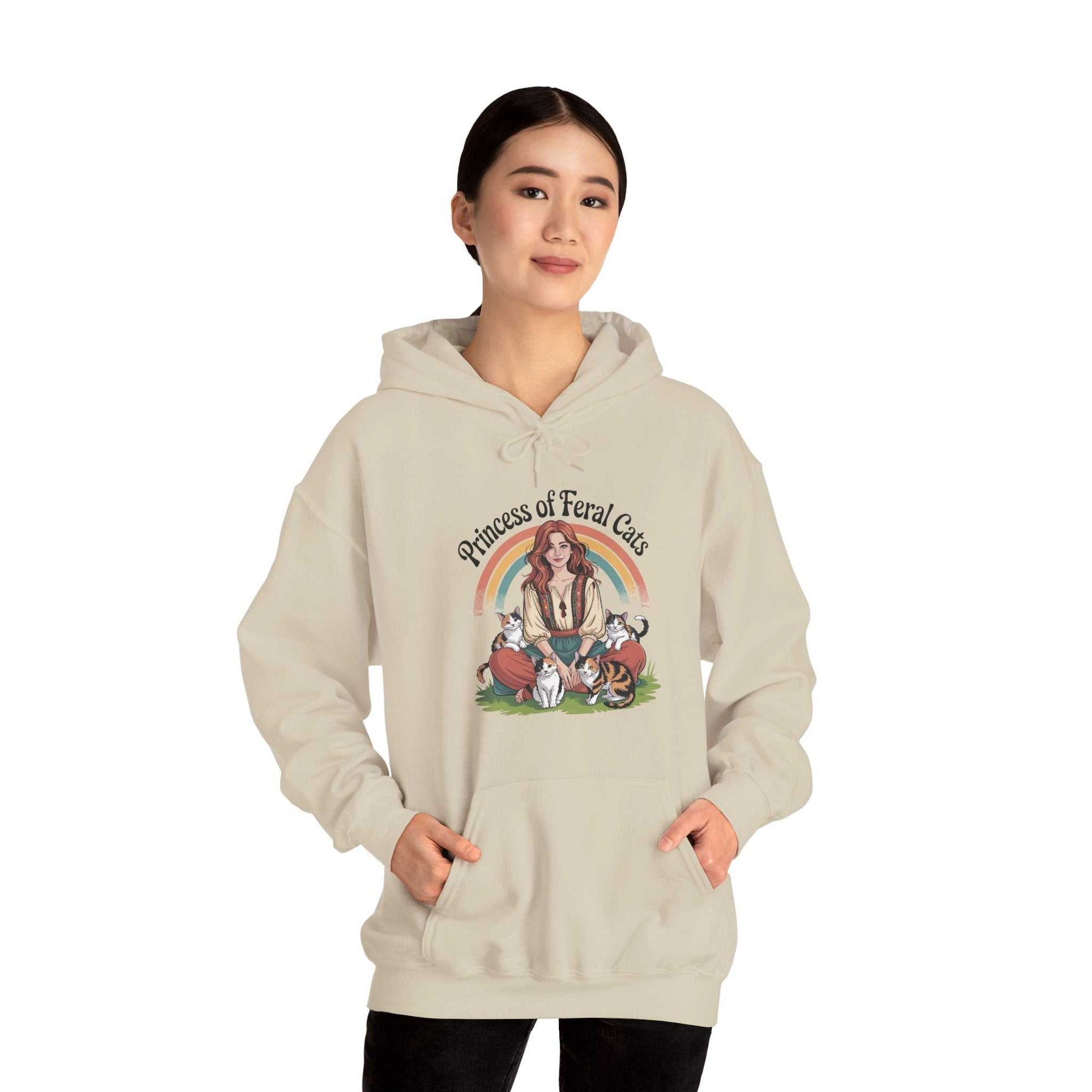 Person wearing a beige hoodie with a graphic design on a white background