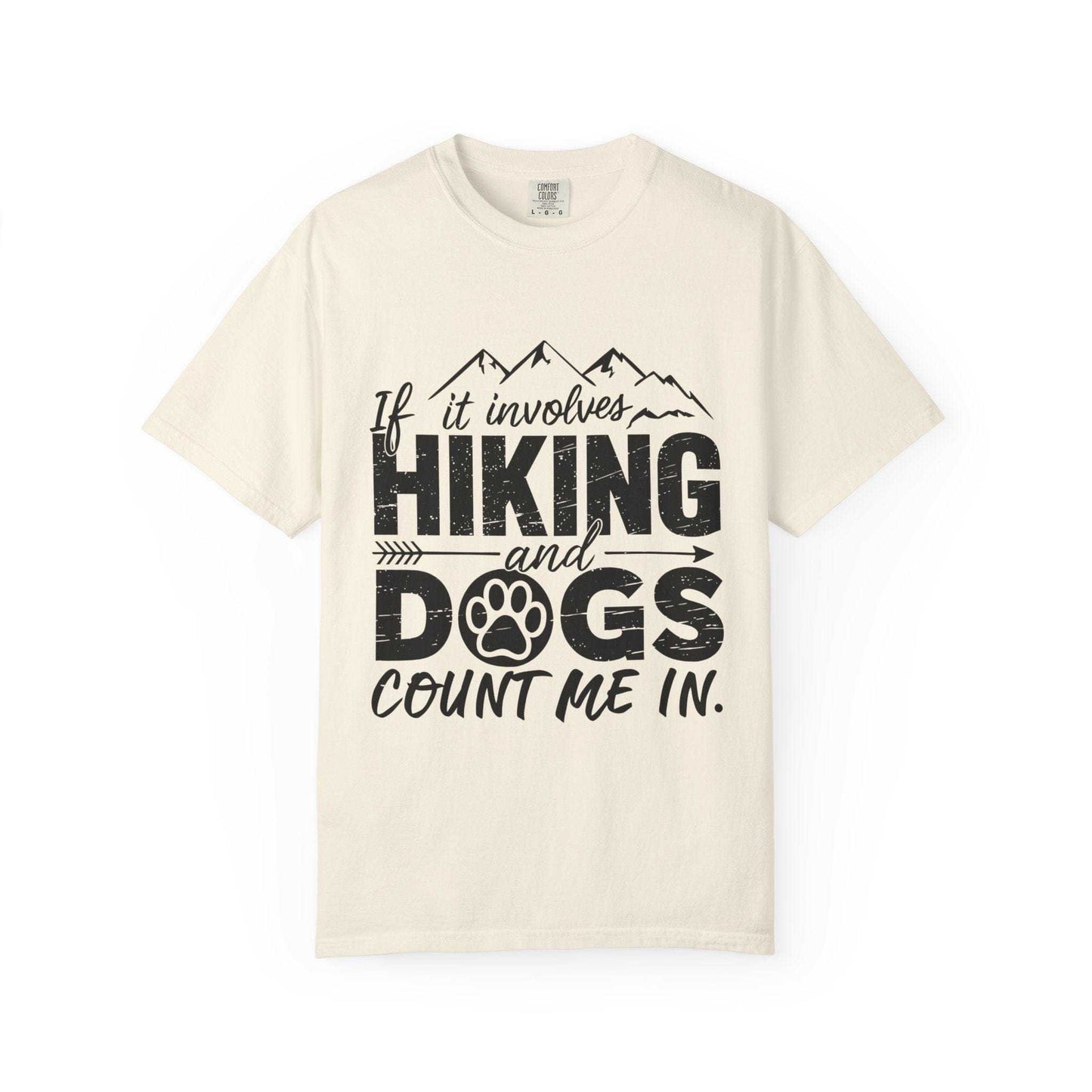 Beige t-shirt with black text 'If it involves hiking and dogs count me in.' on a white background