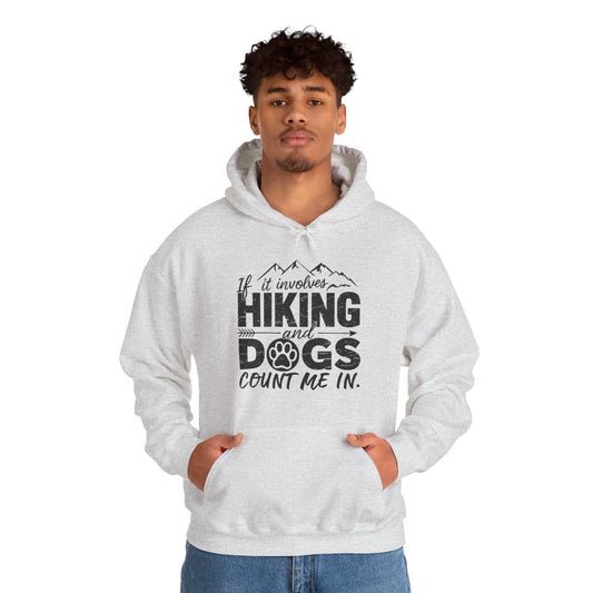 Person wearing a hoodie with 'If it involves hiking and dogs, count me in' text on a white background